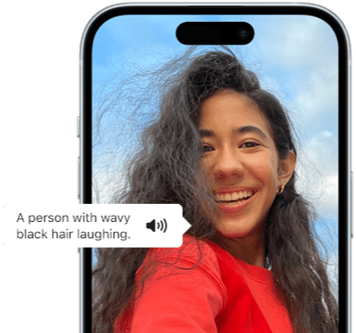 iPhone 15 displaying a Voiceover announcement describing a photograph as: a person with wavy black hair laughing