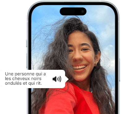 iPhone 15 affichant une annonce de VoiceOver décrivant une personne qui a les cheveux noirs ondulés et qui rit